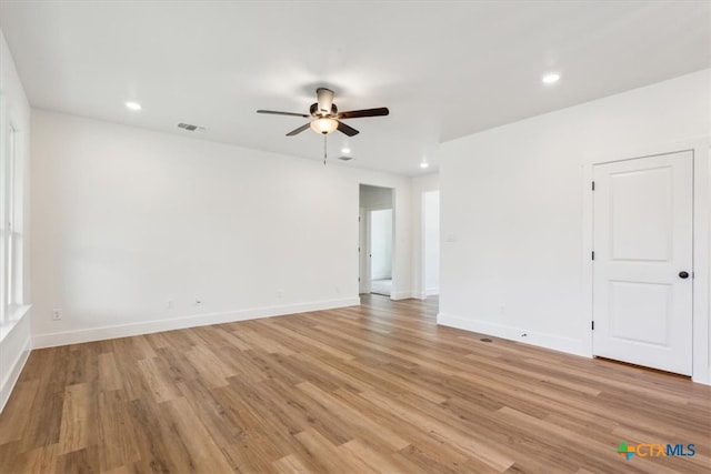 empty room featuring light hardwood / wood-style flooring and ceiling fan