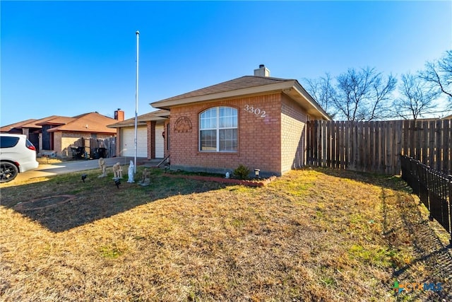 view of front of home with a garage and a front yard