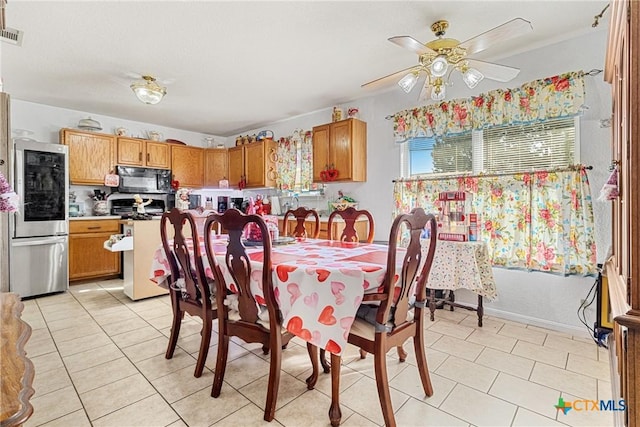 dining room with ceiling fan and light tile patterned flooring