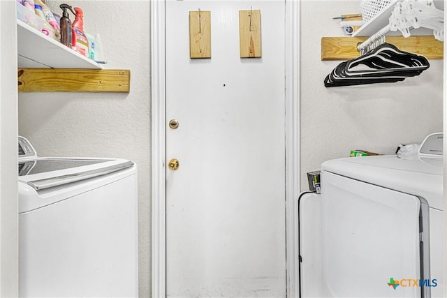 clothes washing area featuring separate washer and dryer