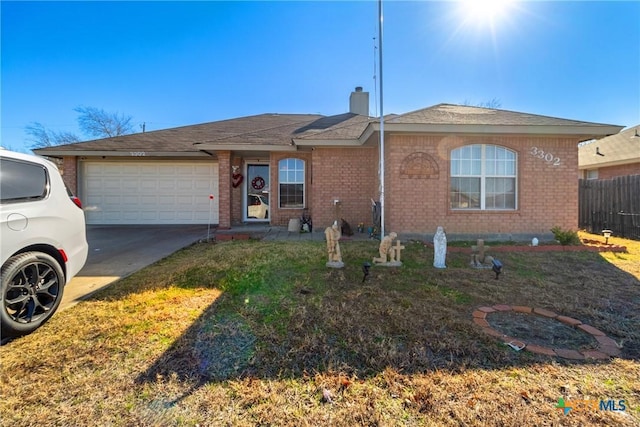 ranch-style home with a garage and a front lawn