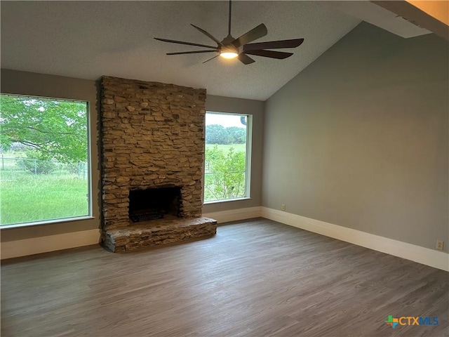 3705 Oakridge Blvd, Harker Heights, TX 76548 - unfurnished living room featuring ceiling fan, baseboards, wood finished floors, a fireplace, and vaulted ceiling