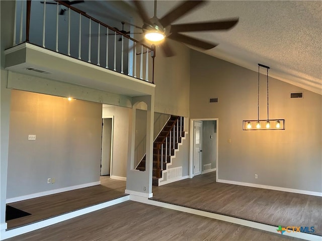 3705 Oakridge Blvd, Harker Heights, TX 76548 - unfurnished living room with a ceiling fan, high vaulted ceiling, stairway, wood finished floors, and baseboards