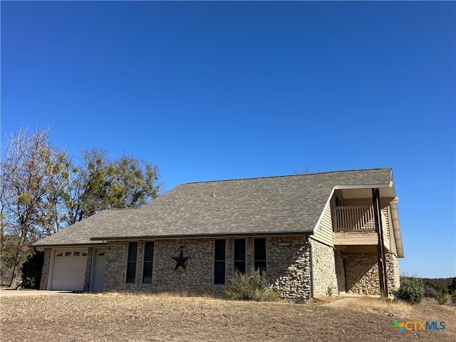 view of front of home with a balcony and a garage