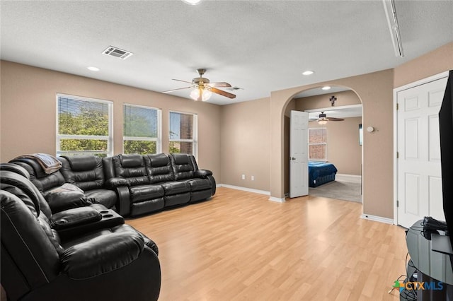 2123 Grizzly Trl, Harker Heights, TX 76548 - living area with ceiling fan, arched walkways, light wood-type flooring, a textured ceiling, and recessed lighting