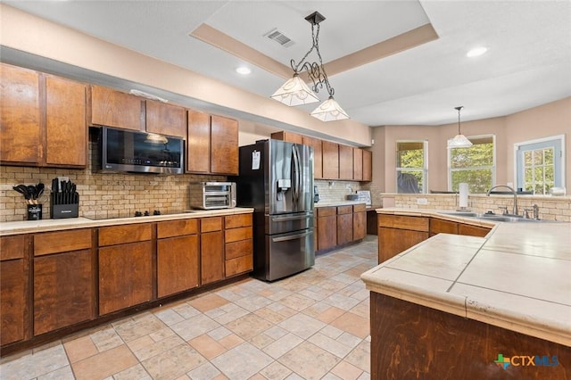 2123 Grizzly Trl, Harker Heights, TX 76548 - kitchen with appliances with stainless steel finishes, decorative backsplash, light countertops, hanging light fixtures, and recessed lighting
