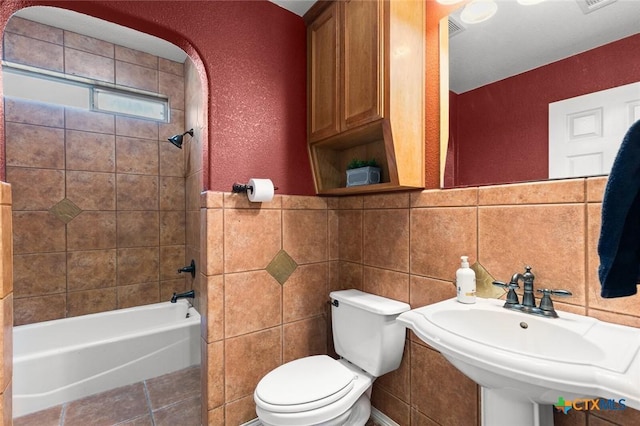 2123 Grizzly Trl, Harker Heights, TX 76548 - bathroom with shower / bathtub combination, tile patterned flooring, and tile walls