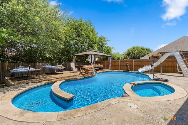 2123 Grizzly Trl, Harker Heights, TX 76548 - view of pool with a gazebo, a water slide, a fenced backyard, a pool with connected hot tub, and a patio