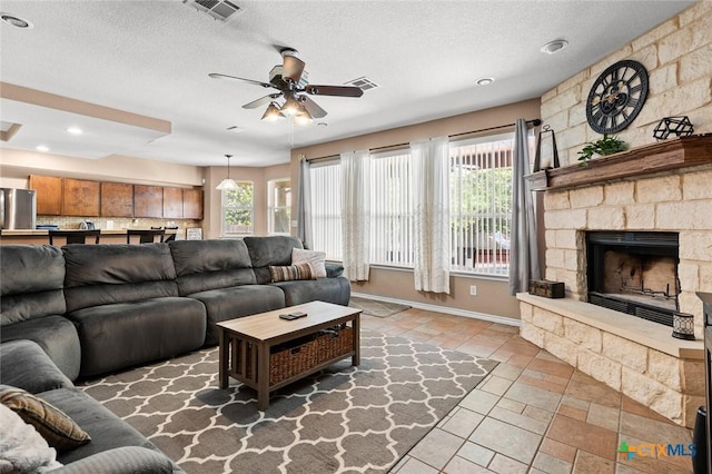 2123 Grizzly Trl, Harker Heights, TX 76548 - living area with a ceiling fan, a fireplace, a textured ceiling, and recessed lighting