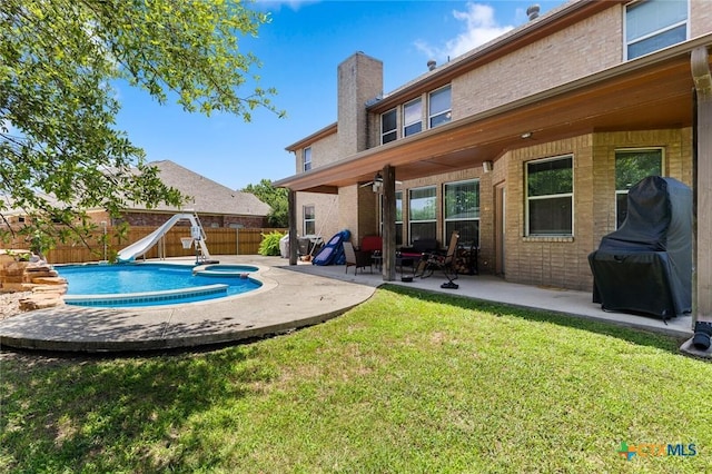 2123 Grizzly Trl, Harker Heights, TX 76548 - back of house featuring a fenced backyard, brick siding, a chimney, a patio, and a pool with connected hot tub