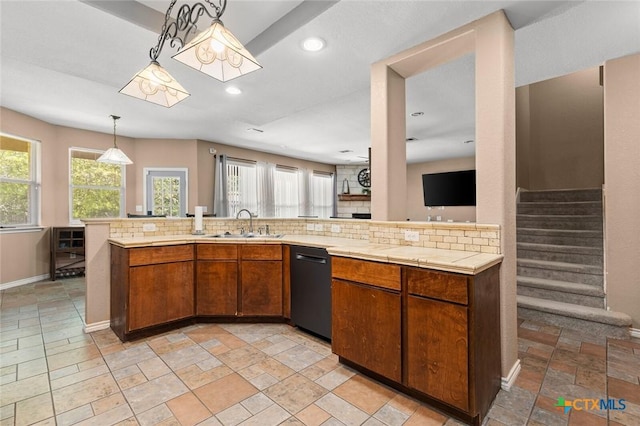 2123 Grizzly Trl, Harker Heights, TX 76548 - kitchen featuring black dishwasher, light countertops, backsplash, stone tile flooring, and brown cabinetry