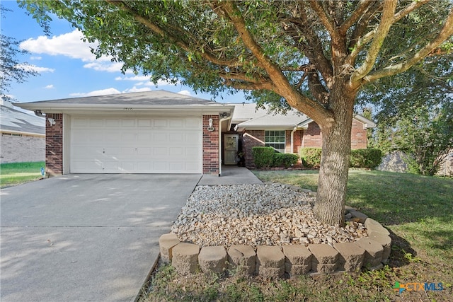 ranch-style home featuring a garage and a front lawn