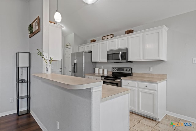 kitchen with white cabinetry, kitchen peninsula, and stainless steel appliances