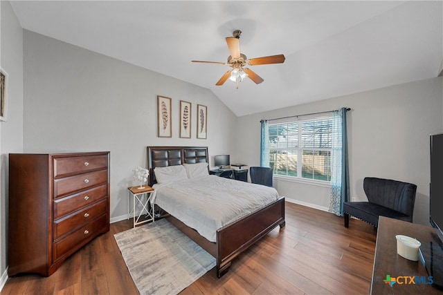 bedroom with lofted ceiling, ceiling fan, and dark wood-type flooring