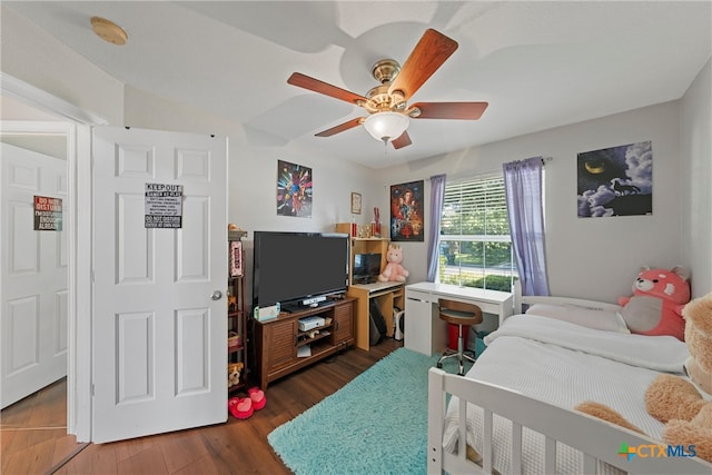 bedroom with dark wood-type flooring and ceiling fan