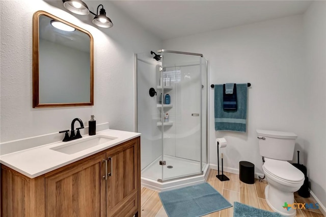 408 W Forrest St, Victoria, TX 77901 - full bath with a shower stall, vanity, toilet, and wood finished floors