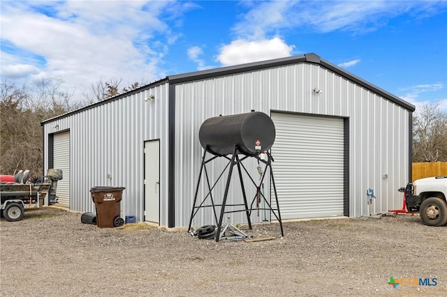 view of outbuilding with driveway and an outdoor structure