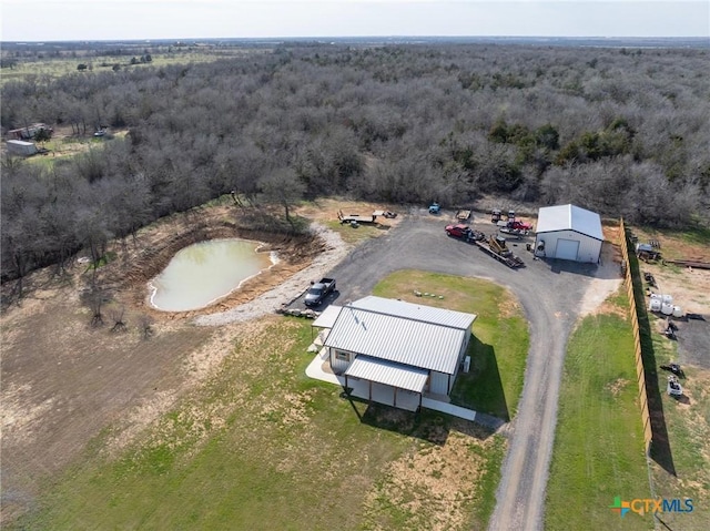 drone / aerial view featuring a view of trees