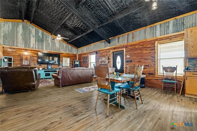 dining room with a ceiling fan, high vaulted ceiling, and wood finished floors