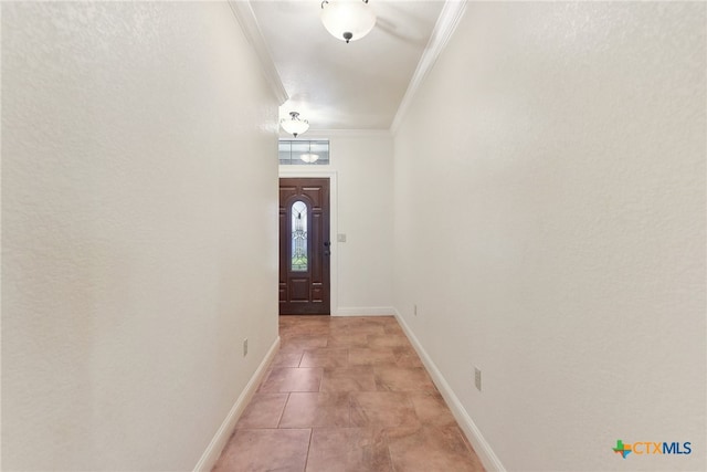 entryway with ornamental molding and light tile patterned flooring