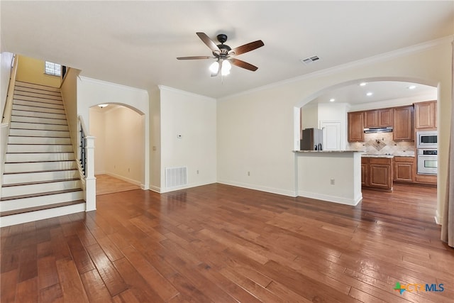 unfurnished living room with ceiling fan, dark hardwood / wood-style flooring, and ornamental molding