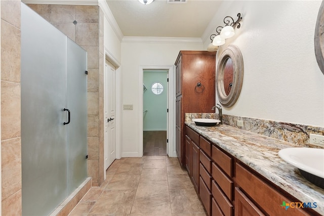 bathroom with vanity, an enclosed shower, ornamental molding, and tile walls