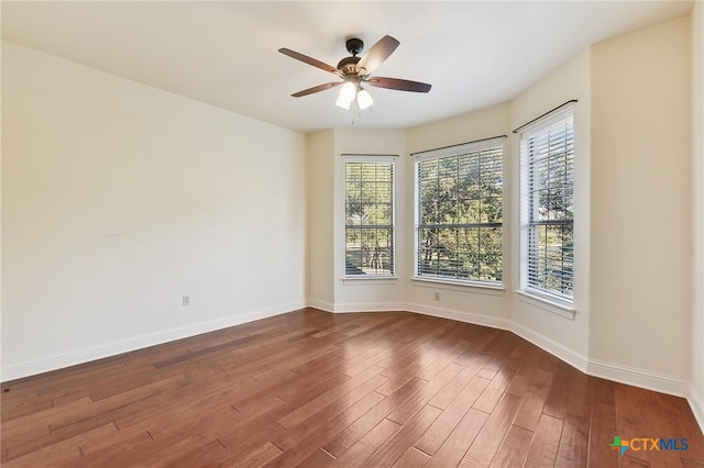 empty room featuring ceiling fan and dark wood-type flooring