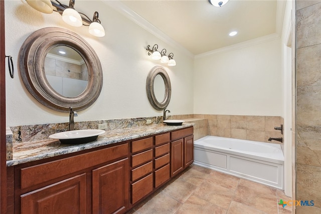 bathroom with crown molding, vanity, and a bath