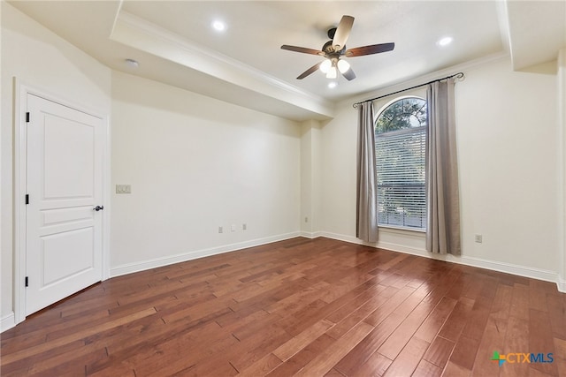 spare room with dark hardwood / wood-style floors, ceiling fan, and ornamental molding