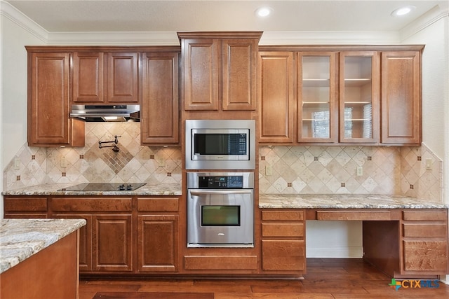 kitchen with backsplash, dark wood-type flooring, and stainless steel appliances