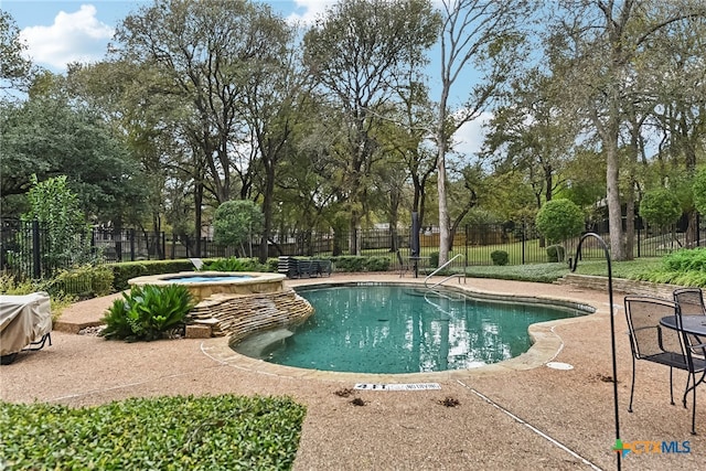 view of pool featuring a hot tub and a patio area