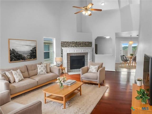 6502 Griffith Loop, Killeen, TX 76549 - living room featuring ceiling fan, a high ceiling, wood finished floors, and a premium fireplace