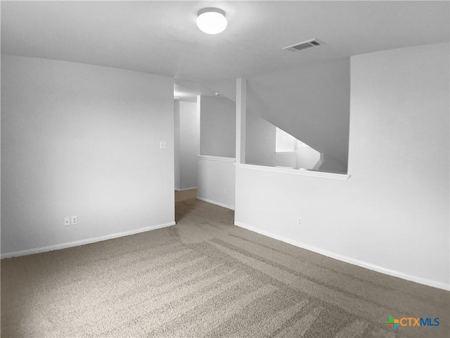 6502 Griffith Loop, Killeen, TX 76549 - empty room featuring carpet floors, baseboards, lofted ceiling, and visible vents