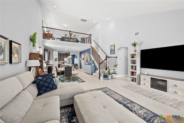 27522 Paraiso Sands, Boerne, TX 78015 - living room with stairway, high vaulted ceiling, arched walkways, and recessed lighting
