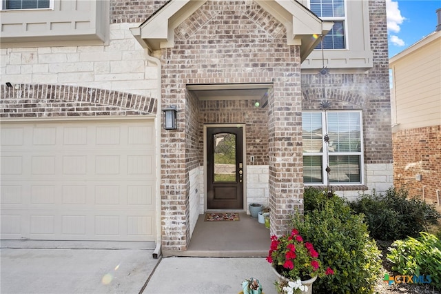 27522 Paraiso Sands, Boerne, TX 78015 - property entrance featuring brick siding, driveway, an attached garage, and stone siding