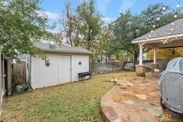 view of yard featuring a patio area and a storage shed