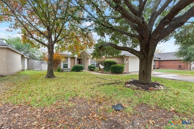 ranch-style home featuring a garage and a front lawn