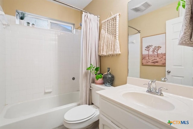 full bathroom with vanity, toilet, and shower / tub combo