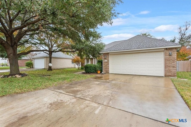 view of front of property with an outbuilding, a front yard, and a garage