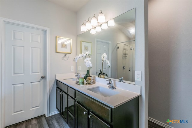 3130 Wigeon Way, Copperas Cove, TX 76522 - bathroom featuring double vanity, a stall shower, and wood finished floors