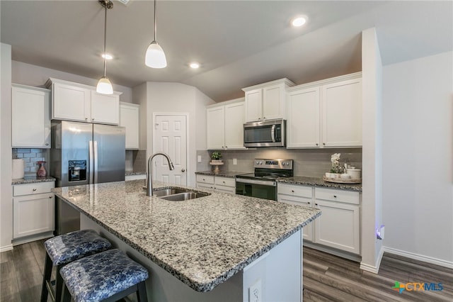 3130 Wigeon Way, Copperas Cove, TX 76522 - kitchen featuring stainless steel appliances, vaulted ceiling, backsplash, dark wood finished floors, and a breakfast bar