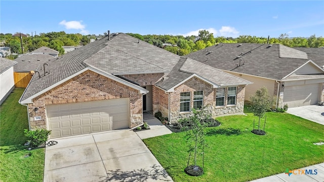 view of front facade with a garage and a front lawn