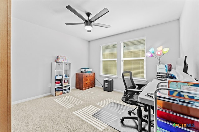 carpeted home office with ceiling fan