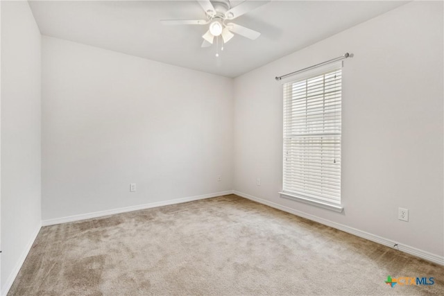 carpeted spare room featuring ceiling fan