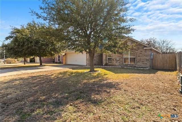 obstructed view of property with a garage and a front lawn