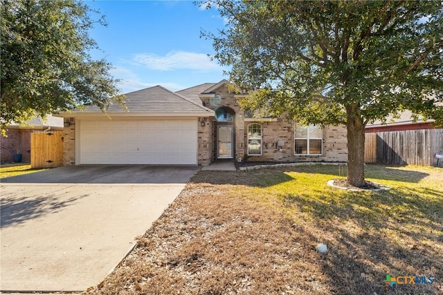 ranch-style house featuring a garage and a front yard