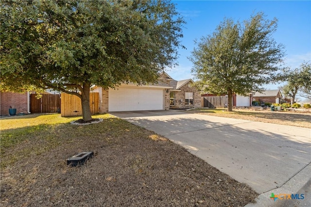 view of property hidden behind natural elements with a garage