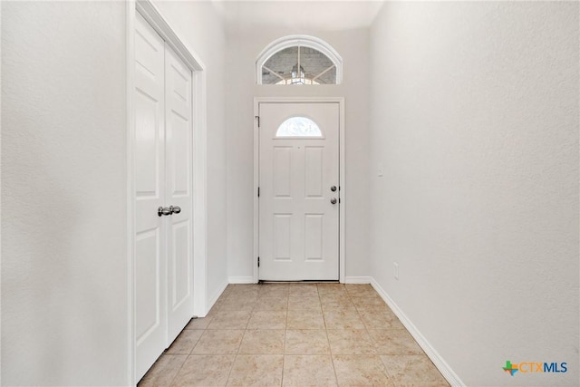 doorway featuring light tile patterned flooring