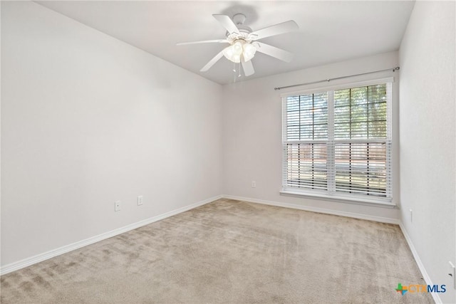 carpeted empty room featuring ceiling fan