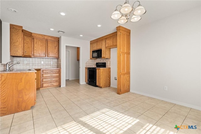 kitchen featuring sink, an inviting chandelier, light tile patterned floors, decorative backsplash, and black appliances